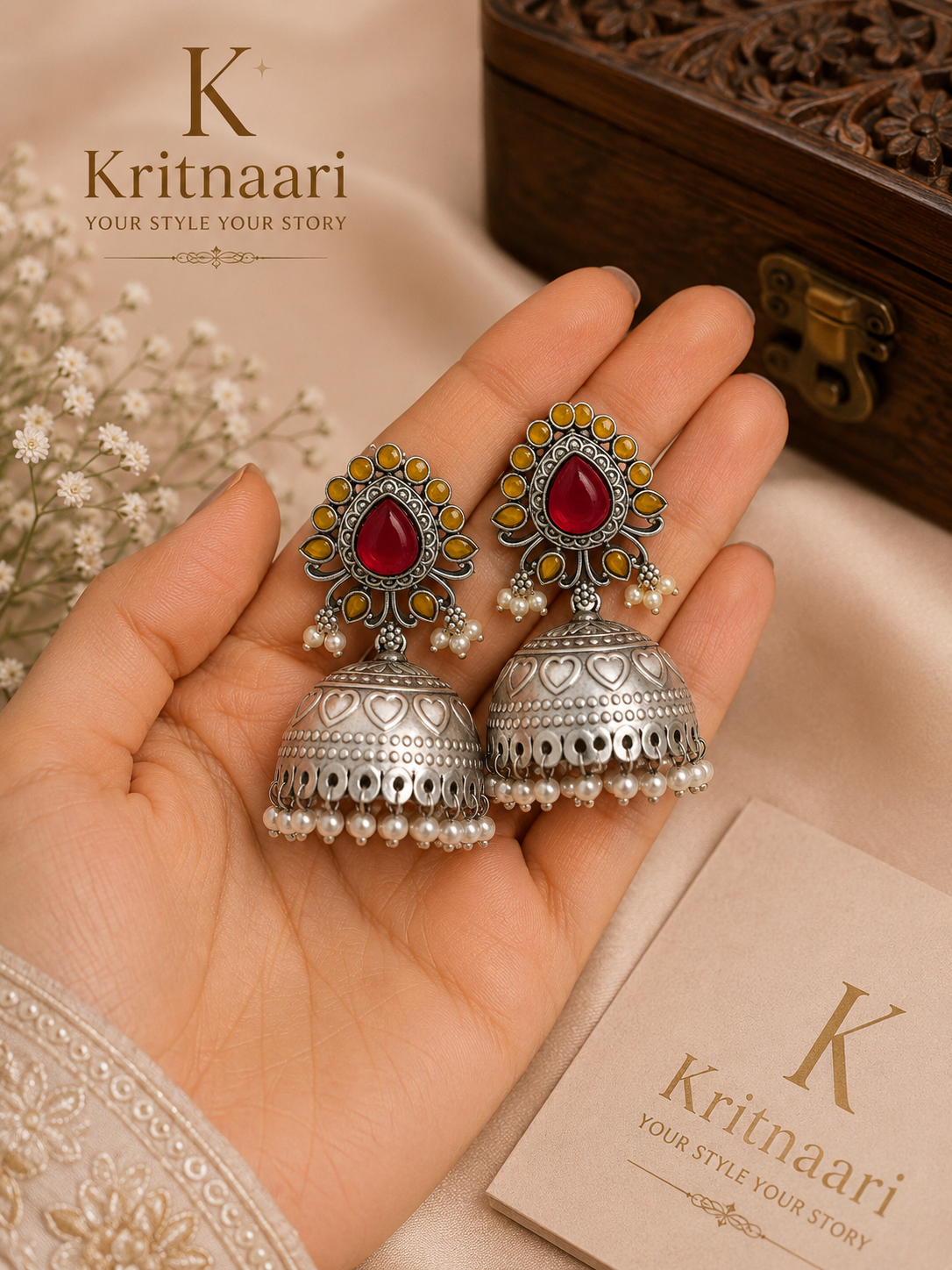 Oxidised silver ruby and amber stone jhumka earrings worn on model - ear view